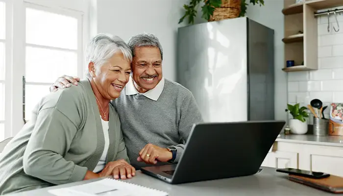 older couple receiving support from loved ones virtually